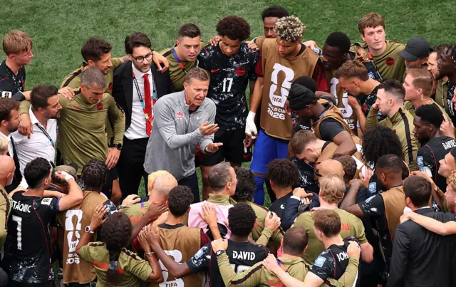 Jesse Marsch, Head Coach of Canada, speaks with his players in a huddle after the team's victory