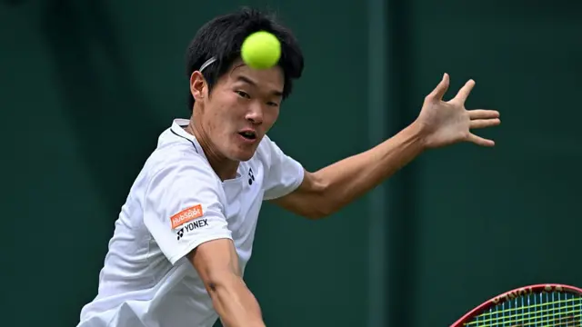 Michael Zheng returns the ball