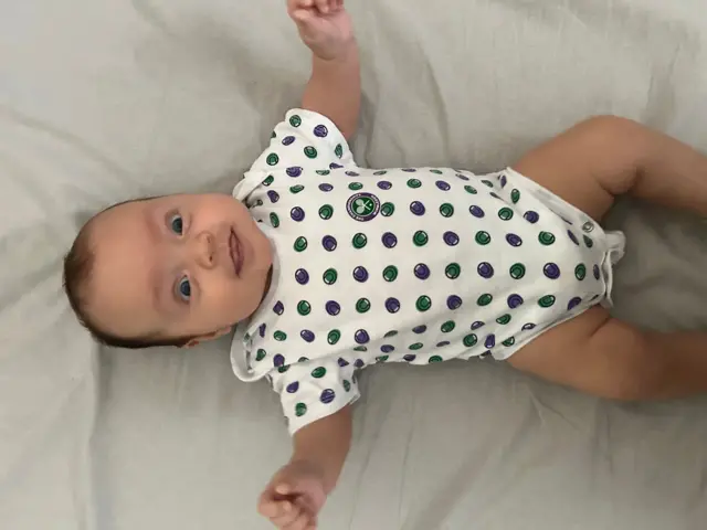 Baby in Wimbledon themed babygrow
