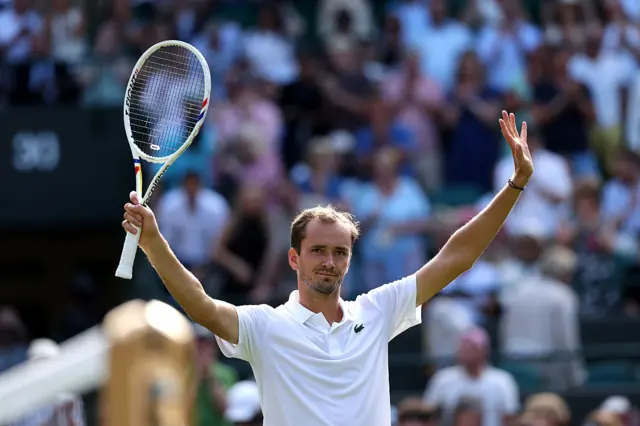 Daniil Medvedev holds arms aloft after winning