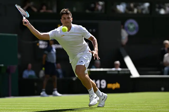 Miomir Kecmanovic returns the ball