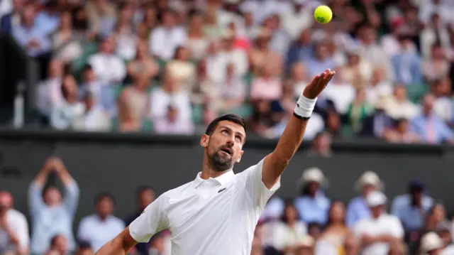 Novak Djokovic serves