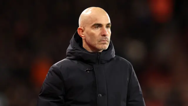 Enzo Maresca. He is wearing a black coat.