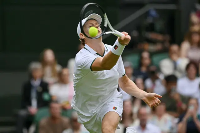Jannik Sinner returns the ball