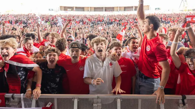 Fans cheer on Canada and the winning goal versus South Africa in the round of 32 match at the Vancouver FanFestival