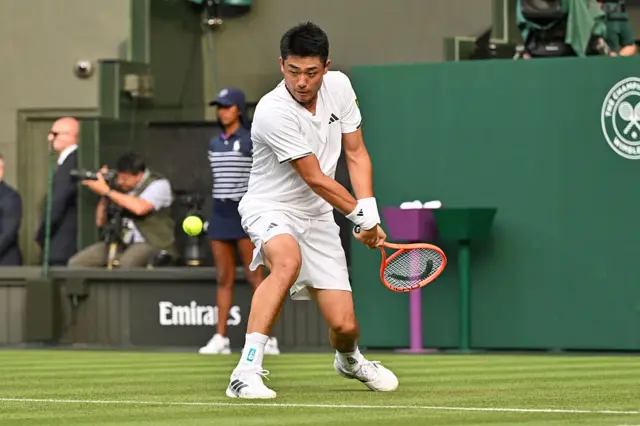 Yibing Wu hits a backhand