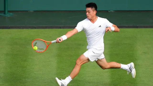 Yibing Wu plays a forehand
