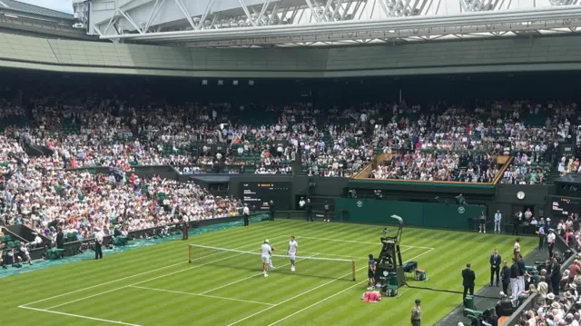 Jannik Sinner walks out on to Centre Court