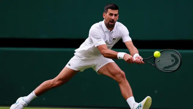Novak Djokovic plays a backhand