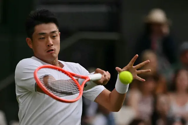 Yibing Wu returns the ball