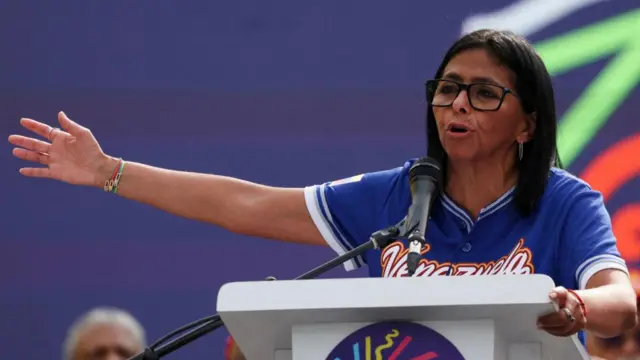 Rodríguez speaks from a podium on stage