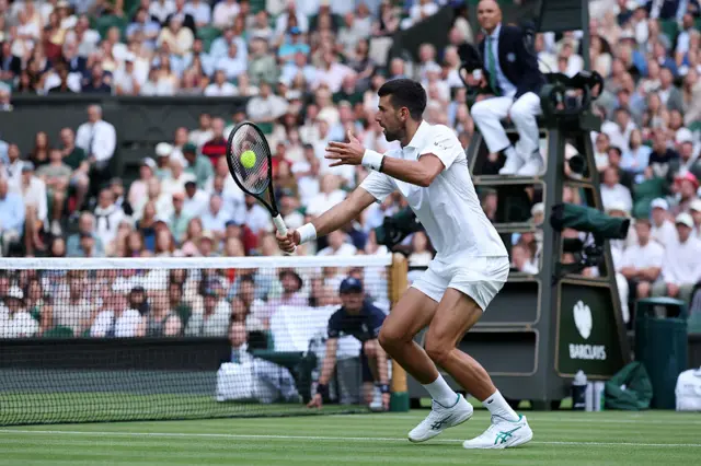 Novak Djokovic of Serbia plays a backhand volley