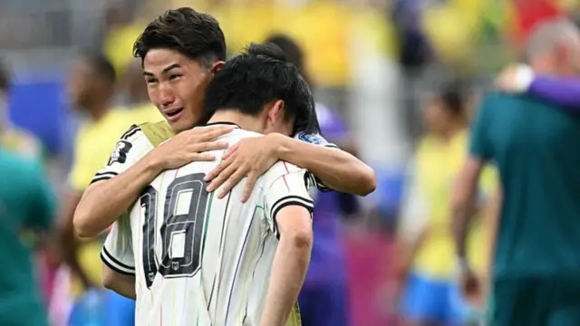 Japan's forward #18 Ayase Ueda (front) reacts at the end of the 2026 World Cup round of 32 football match between Brazil and Japan.