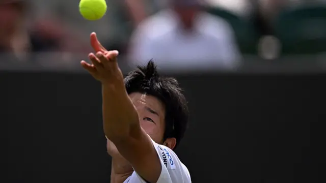 Michael Zheng serves against Cameron Norrie