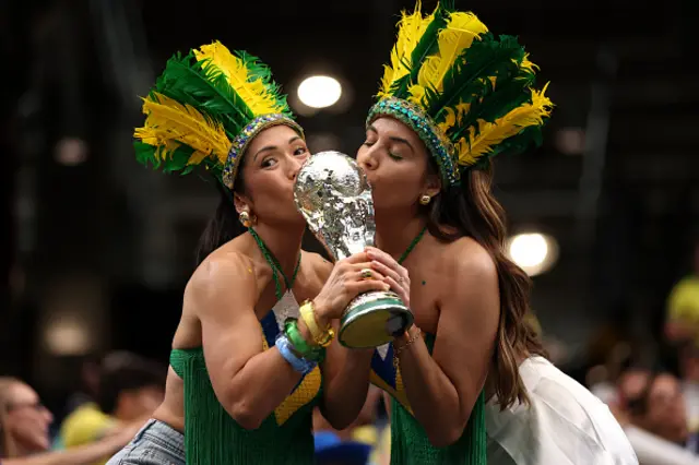 Brazilian fans hold a replica World Cup trophy