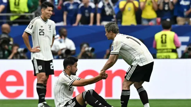 Japan's players react after losing the 2026 World Cup round of 32 football match between Brazil and Japan.