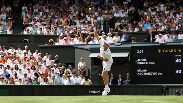 Jannik Sinner of Italy serves