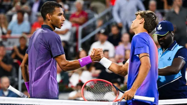 Felix Auger-Aliassime of Canada congratulates Flavio Cobolli