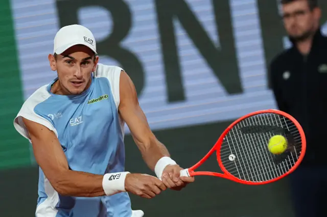 Italy's Matteo Arnaldi plays a backhand return