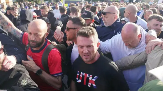 Tommy Robinson with protesters outside Southampton police station.