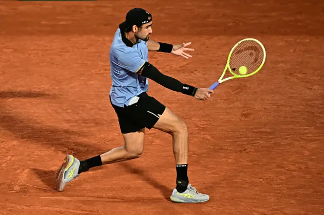 Italy's Matteo Berrettini plays a backhand return