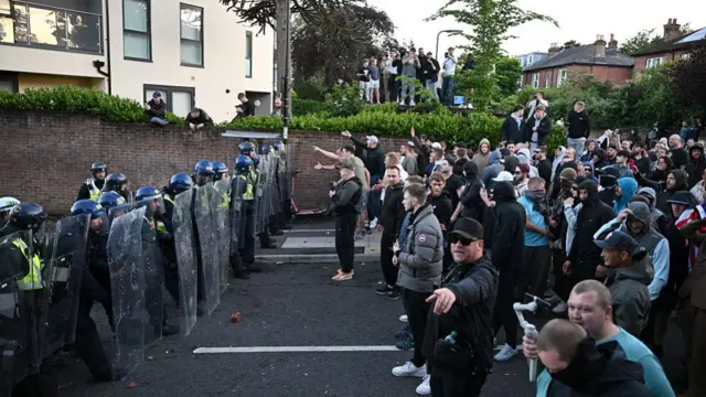 People confront riot police as protesters gather near the location where Henry Nowak died during a demonstration over the Police's handling of the incident, on June 2, 2026 in Southampton, England.