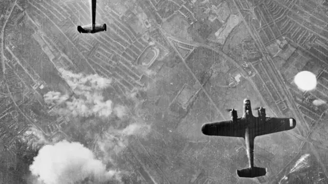 Two large aircraft in a black and white photo seen from above