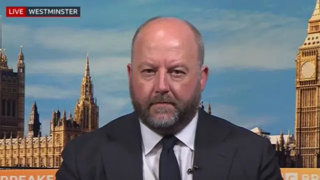 Shadow justice secretary Nick Timothy speaks to BBC Breakfast. An image of Westminster can be seen behind the politician