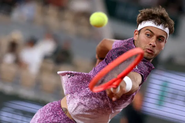 Italy's Flavio Cobolli plays a backhand return