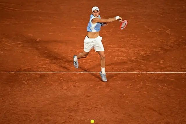 Italy's Matteo Arnaldi plays a forehand
