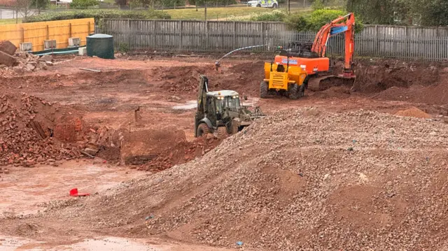 Large vehicles potentially for construction on what could be a building site.