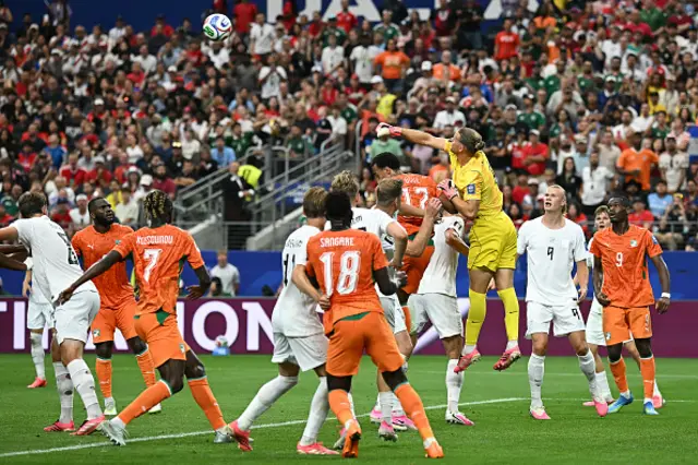 Orjan Nyland (C) jumps to deflect the ball