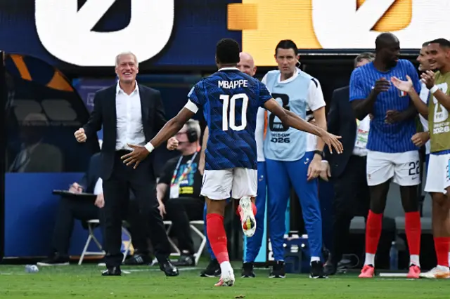 Mbappe celebrates scoring his team's first goal with head coach Didier Deschamps