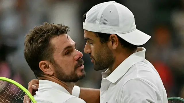 Matteo Berrettini (R) hugs Stan Wawrinka (L)