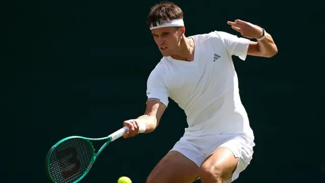 Jakub Mensik hits a forehand