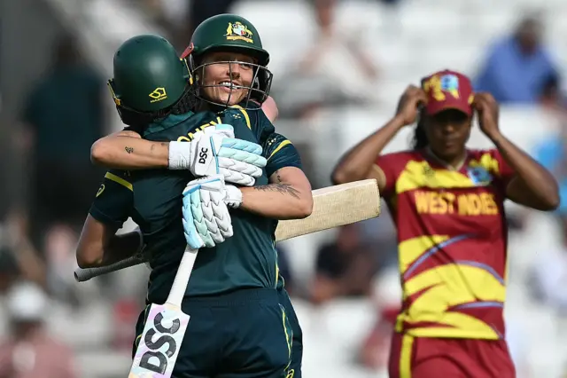 Ash Gardner and Beth Mooney hug after beating West Indies