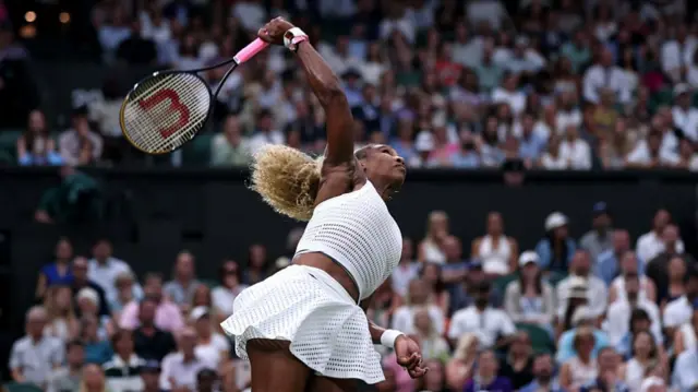 Serena Williams serves