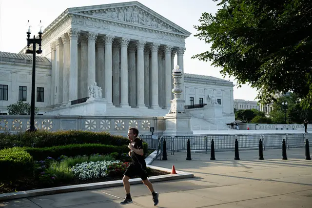 A man runs past the Supreme Court