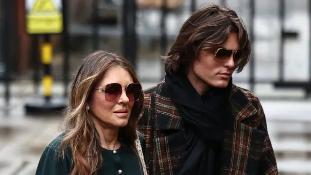 Hurley walks with her son in the street