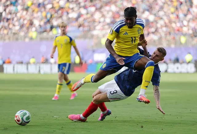 Anthony Elanga #11 of Sweden is challenged by Lucas Digne