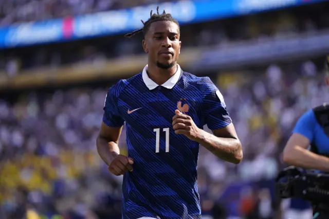 Michael Olise of France looks on