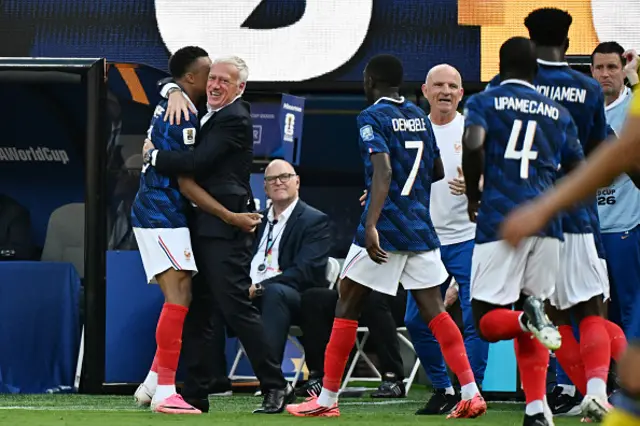 Mbappe celebrates scoring his team's first goal with head coach Didier Deschamps