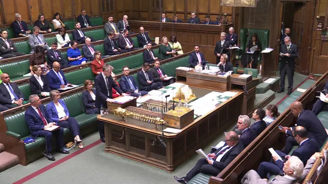 Dan Jarvis speaks in the House of Commons in a wide shot that shows MPs on both sides of the room.