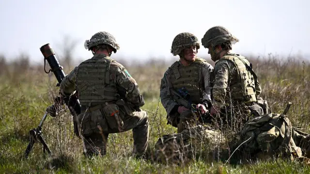 Soldiers from 16 Air Assault Brigade set up a mortar firing position after parachuting from a British Royal Air Force A400M transport aircraft onto Salisbury Plain at Copehill Down training facility