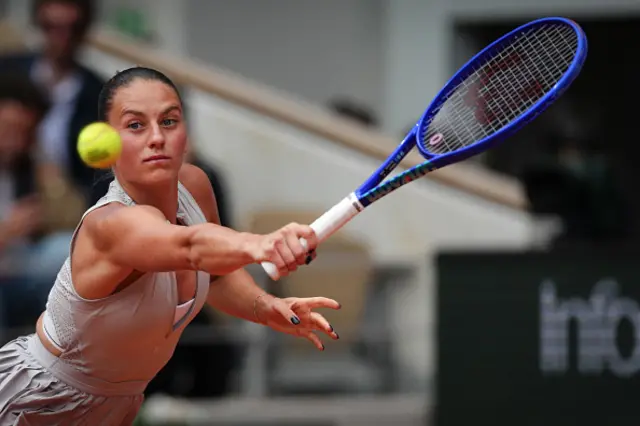 Ukraine's Marta Kostyuk plays a backhand return