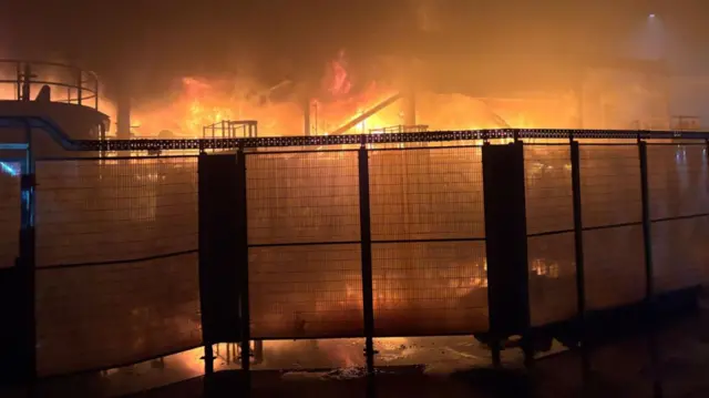 Orange flames and plumes of smoke pictured at Tata Steel plant in Port Talbot