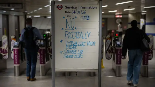 A sign informs people that no Piccadilly Line is running from King's Cross St Pancras station
