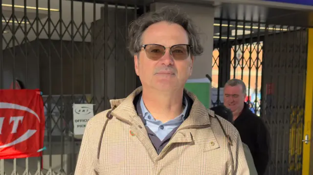 Jared Wood pictured outside a closed barrier gate at a London station