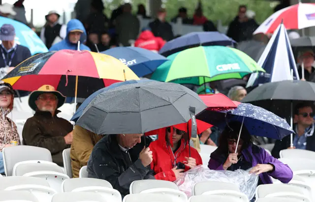 Spectators under umbrellas during the first Test between England and New Zealand at Lord's