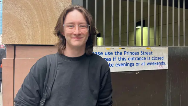 A man with glasses and long hair outside Bank station